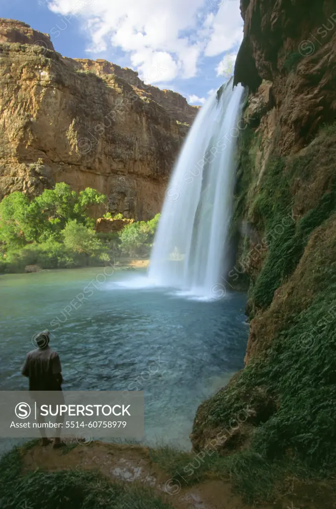 Man looking at Havasu Water Fall in Grand Canyon, AZ.