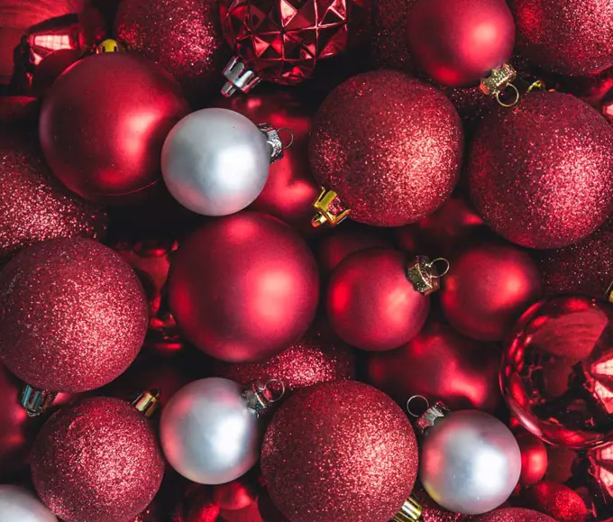 Close up of a variety of red and white Christmas ball ornaments.