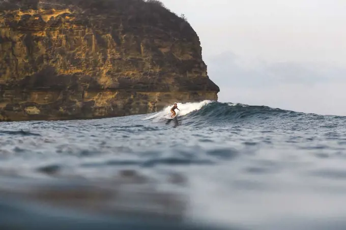 Young woman surfing in Indian Ocean