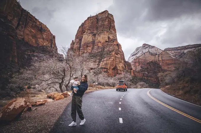 A woman with a child is walking in Zion National Park, Utah