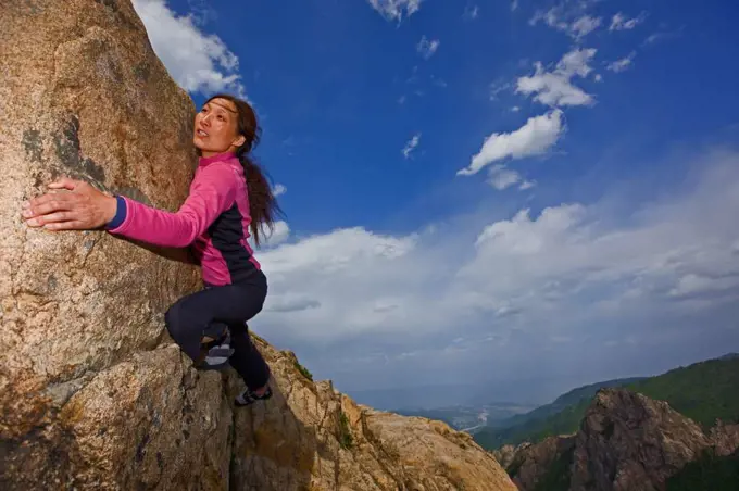 Female climber bouldering at Seroksan national park in South Korea