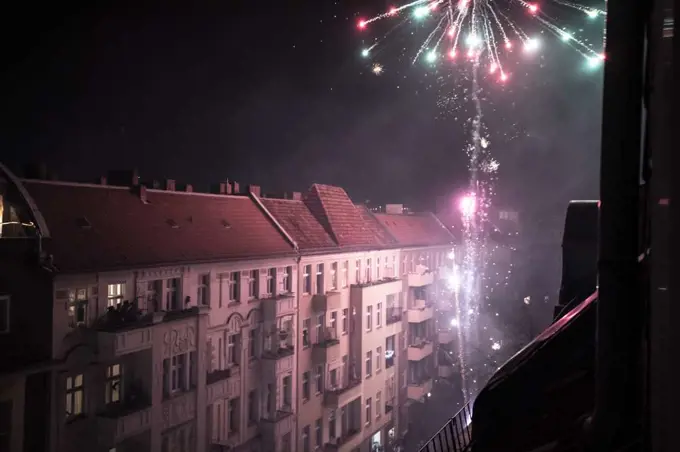 Home fireworks explode from balcony high in Berlin streets new year