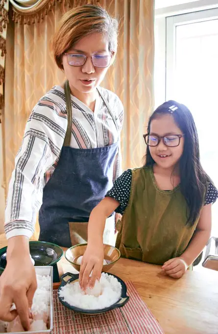 Mother and daughter making the salted egg together