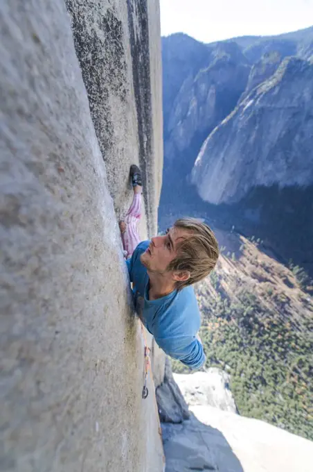 Climbing focused and looking up climbing hard on the Nose Yosemite