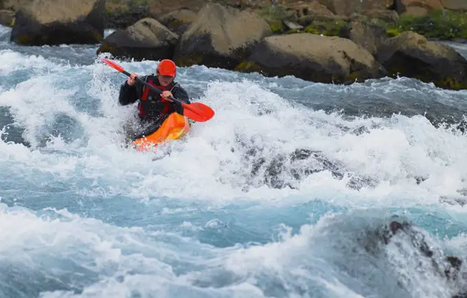 Man going on his white water kayak  rapids in an Icelandic river