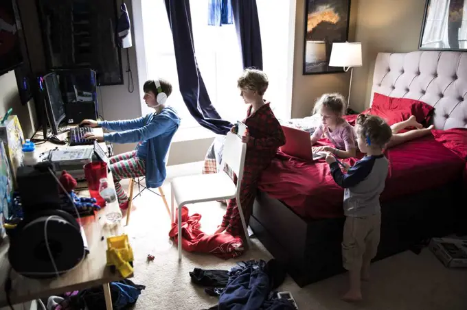 Four Siblings Hanging Out in Messy Teenage Brothers Bedroom