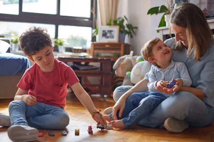 LOVING MOMENT OF HAPPY MOTHER PLAYING WITH HER CHILDREN