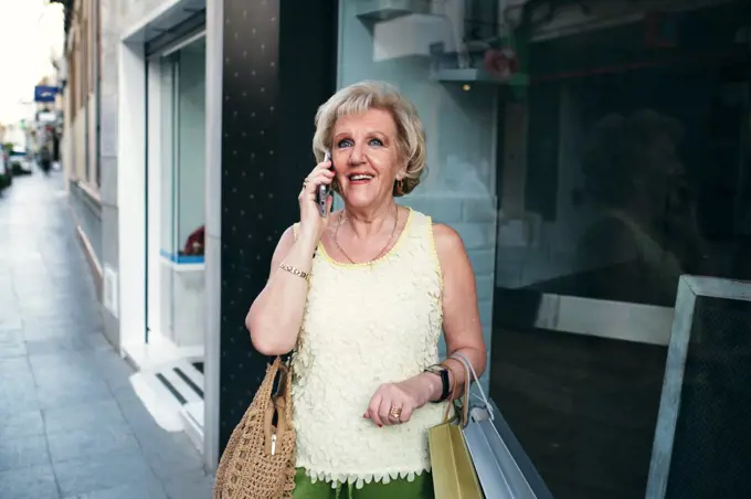 ladies talking on the phone with their shopping bags