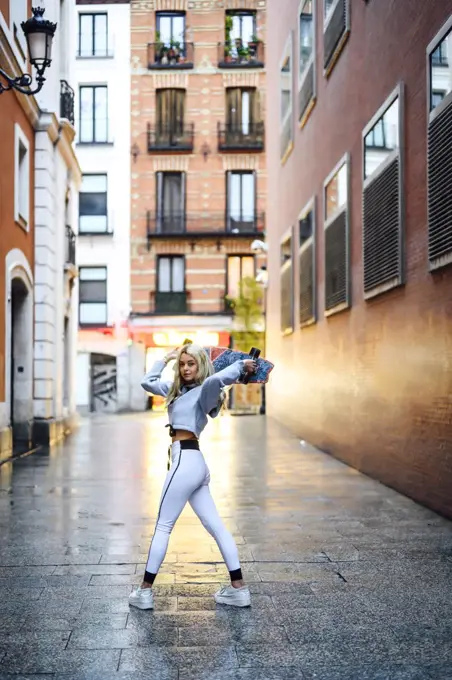 woman turning with skateboard on her head