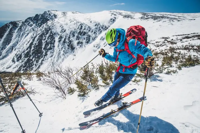 Backcountry skier clipping in above Tuckerman Ravine, NH