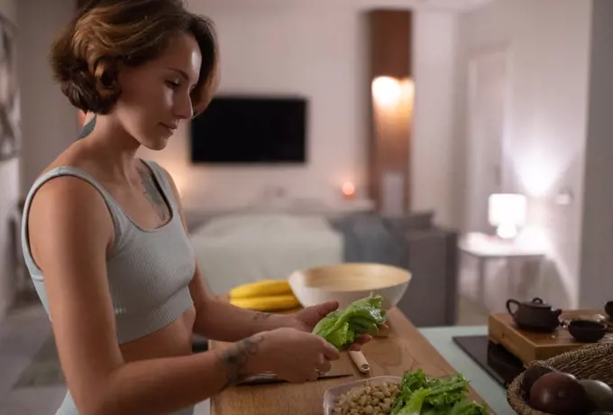 Young woman cooking healthy meal