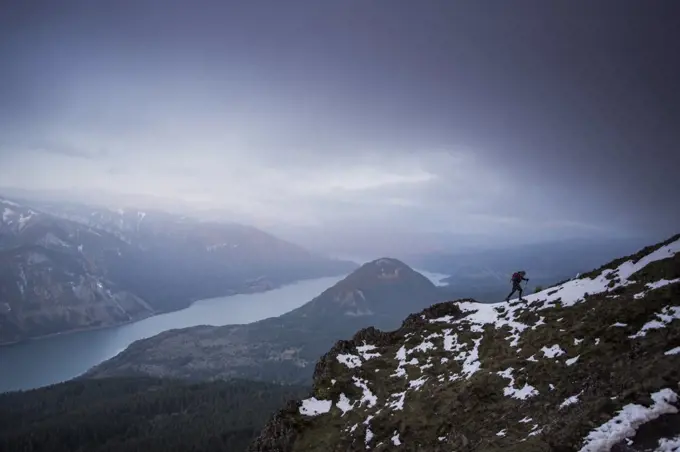 A young man climbs on Dog Mountain overlooking the Columbia Gorge.