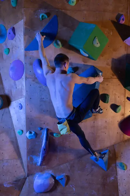 Unrecognizable boulderer on climbing wall