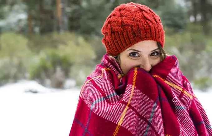 Caucasian woman standing in snowy forest