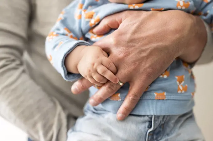 a dad holds his child in his arms