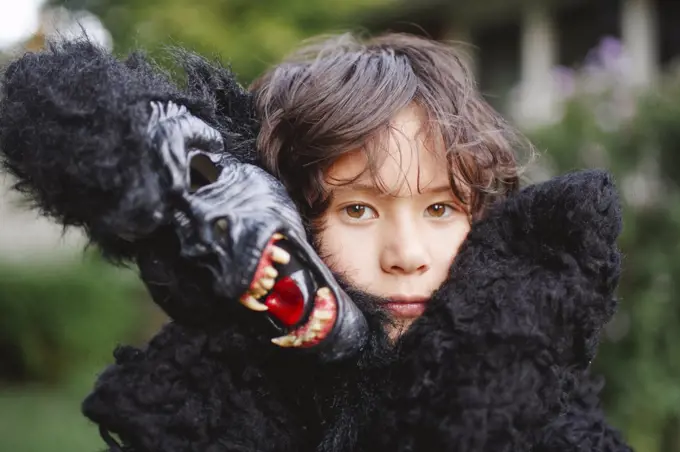 close-up of beautiful boy wearing a gorilla costume outside