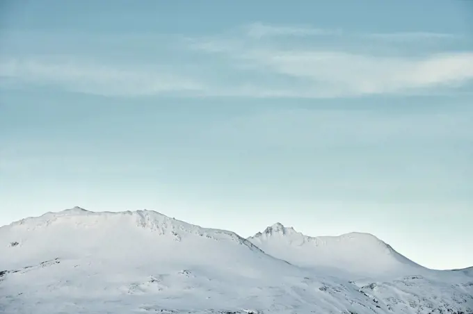 Snowy mountains against blue sky