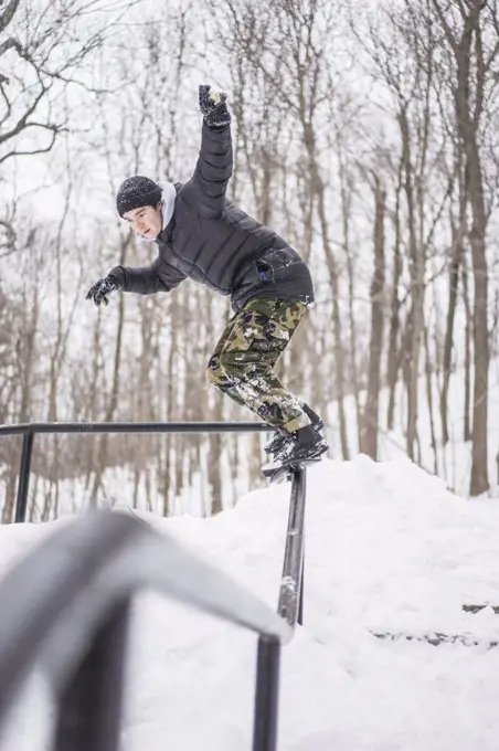 Friends snowskating during winter in forest