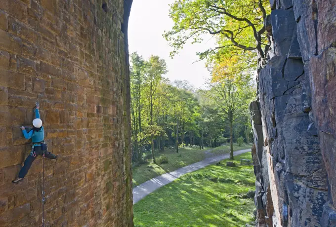 woman climbing up on man made viaduct in Sheffield