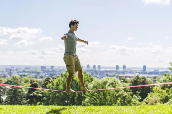 Athletic man attempting to slackline