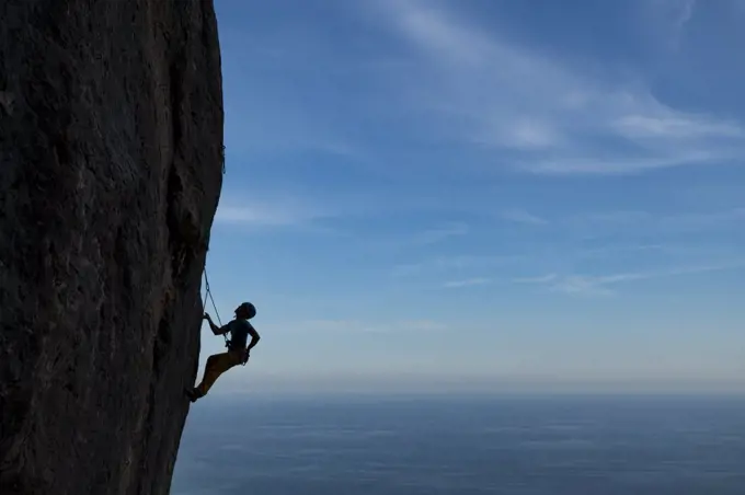 Female rock climber in  Olta mountain, Calpe, Costa Blanca, Alicante Province, Spain