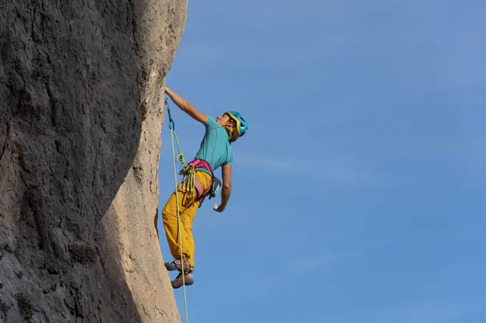 Female rock climber in  Olta mountain, Calpe, Costa Blanca, Alicante Province, Spain