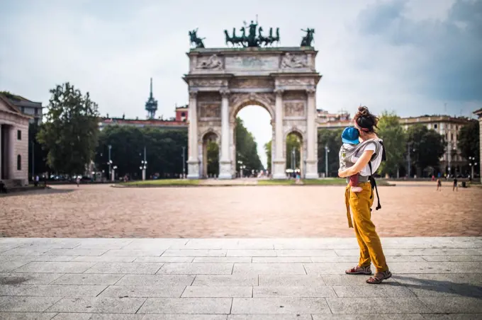 Mother carrying her baby visiting Milan