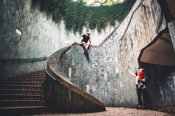 Happy family with baby in some modern stairs in Singapore