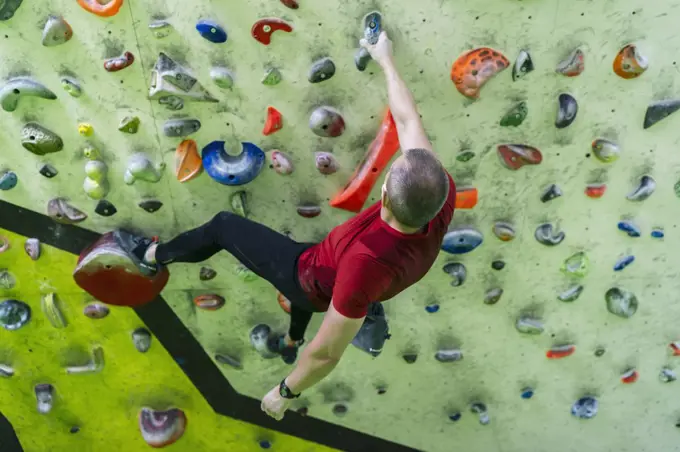 boy training climbing in the climbing wall