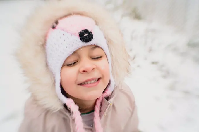 Young girl child happy in snow smiling