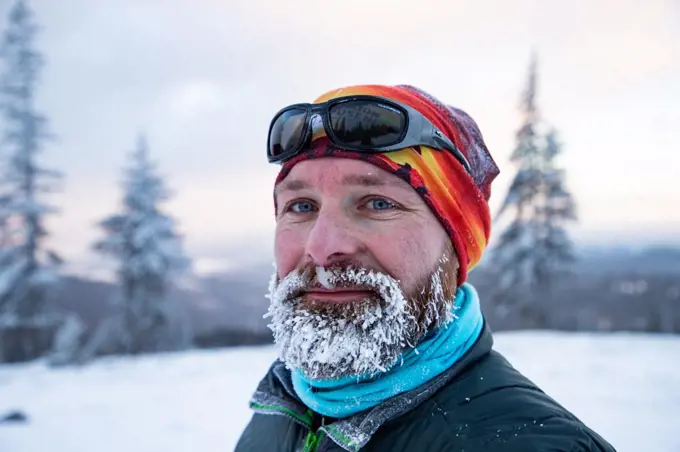 man in extreme weather in winter mountains