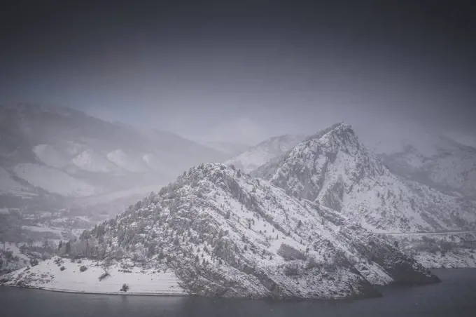 snow-capped mountains adjacent to reservoir