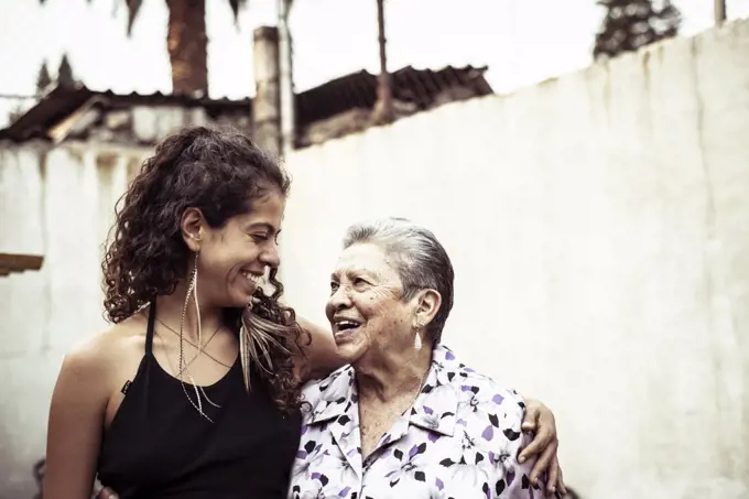 Smiling embrace in a bright summer day of Mexican women in family