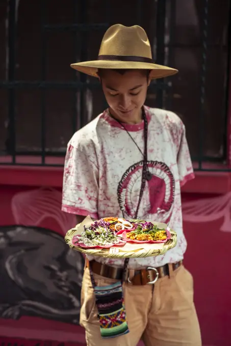 Young mixed race alternative traveller with pink Burritto in Mexico