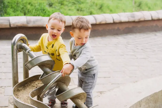 Twin brothers explore the metal construction of the Archimedes screw