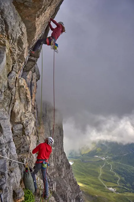 Woman on a difficult rock climb called Odyssee on the Eiger North Face