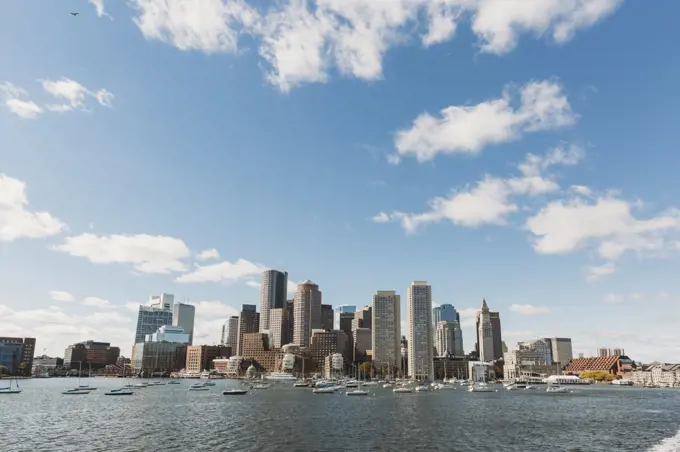 View of Boston City Skyline from offshore against blue sky