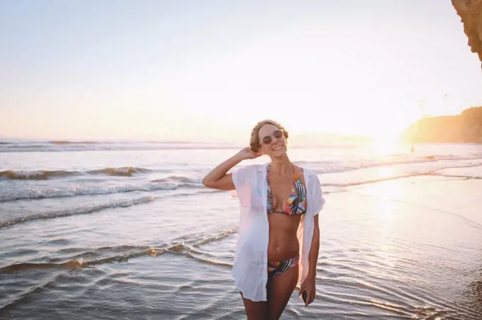 Woman in Tropical  Bikini on the Beach at Sunset