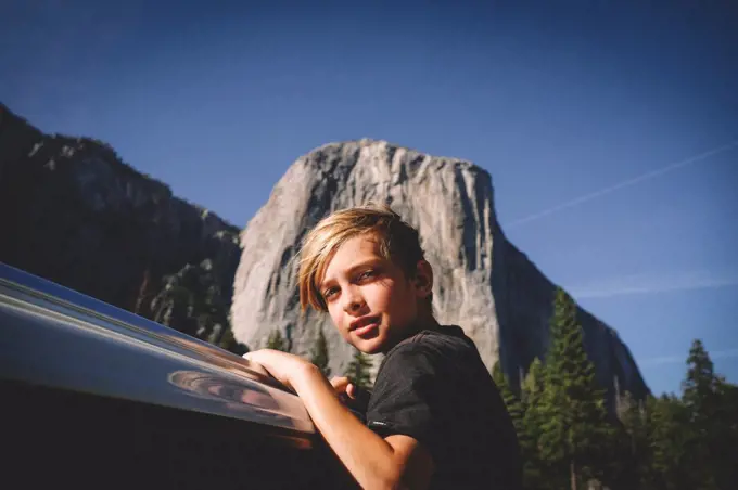 Blonde Boy Hangs from Car window with El Cap in the Background