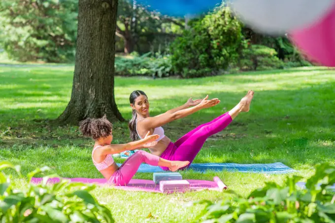 Mother & Daughter stretching in yard