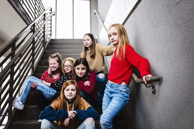 Group of 6 cute Tween girls hanging out having fun in the city.