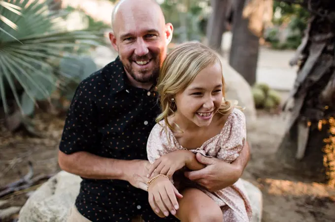 Dad Tickling Daughter in Garden in San Diego