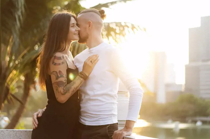 couple in love at sunset in the sunshine in tropical metropolis