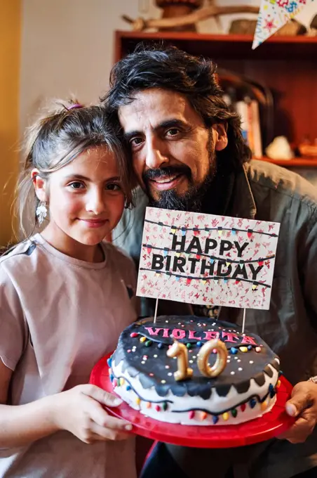 Portrait of a Latino family, father and daughter, celebrating the girl