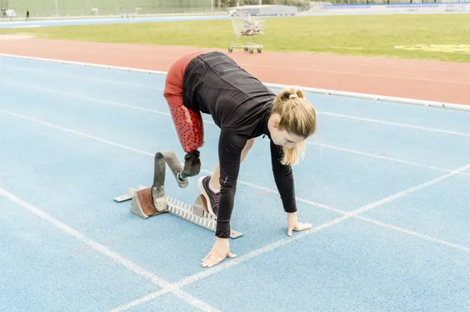 Side view of female athlete with prosthetic leg