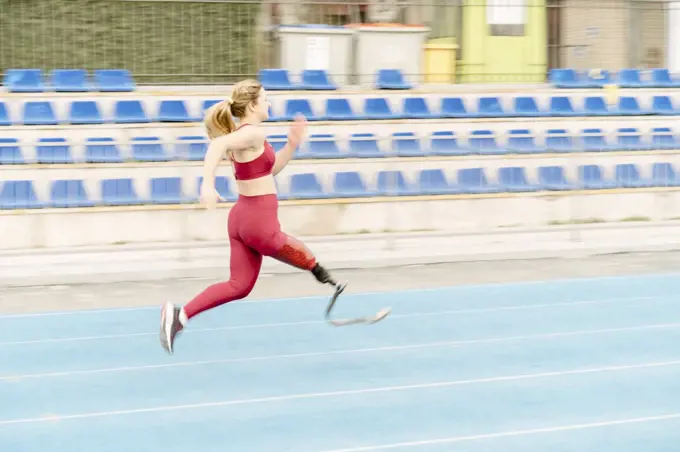 Female athlete with prosthetic leg running