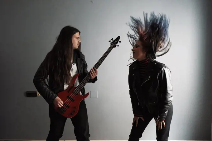 a young couple enjoy themselves while playing the guitar