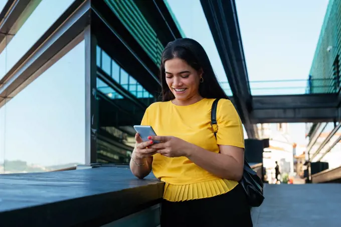 Beautiful young business woman using her phone