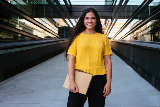 Portrait of a young business woman smiling at camera