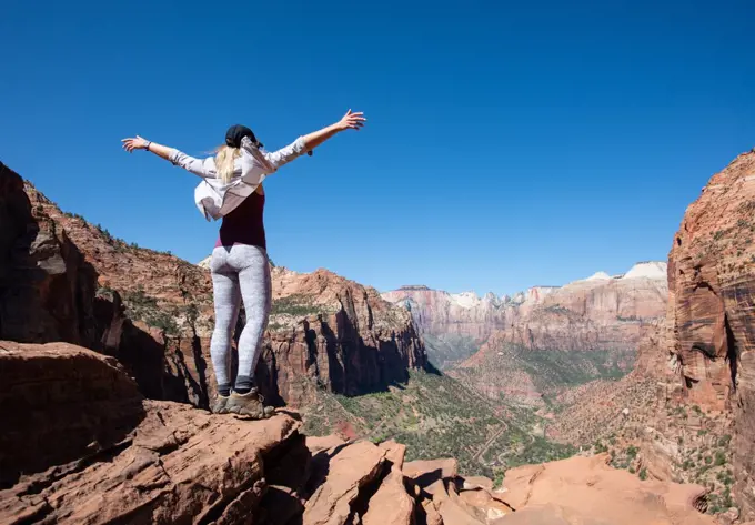 Girl With Hands Up Takes In View Of Zion National Park, Utah